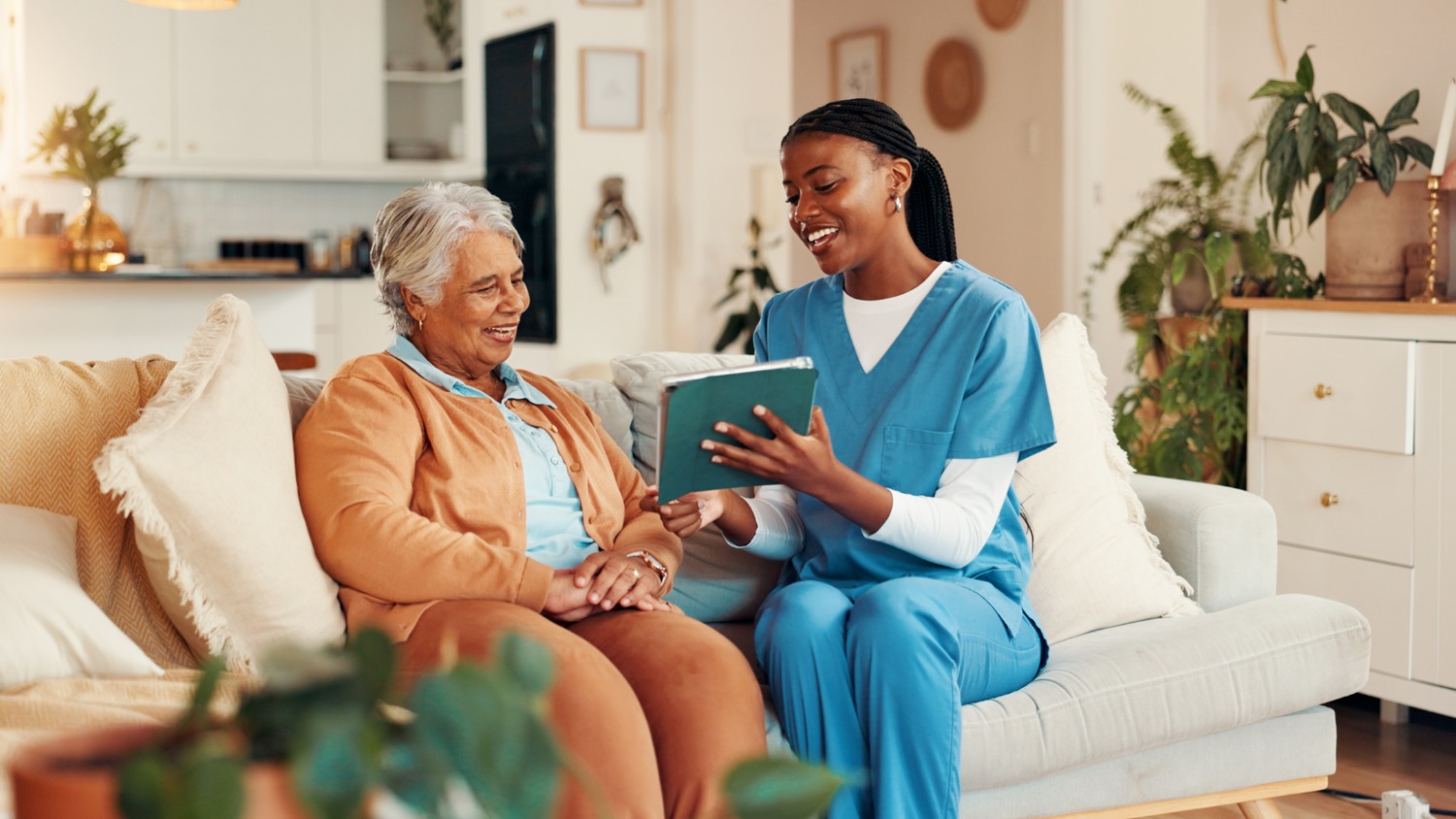 Senior woman and nurse smiling