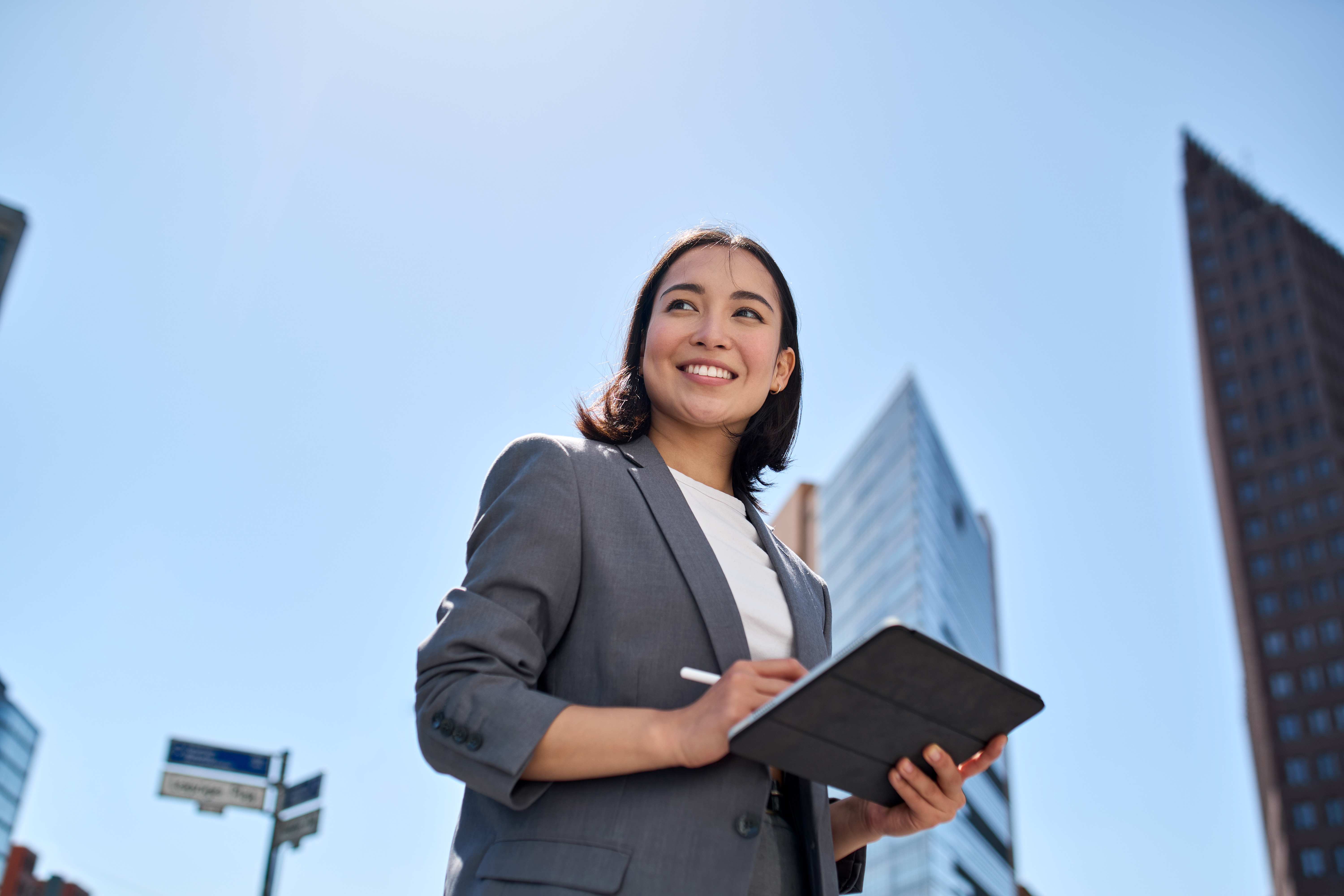 Woman smiling holding tablet