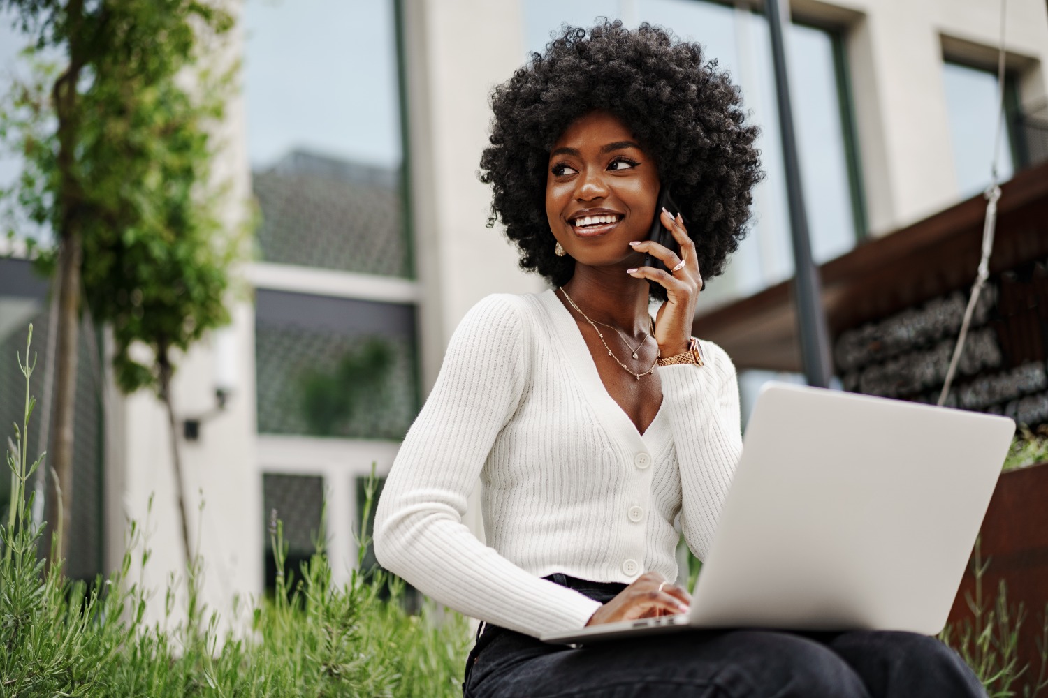 Smiling woman looking away from laptop