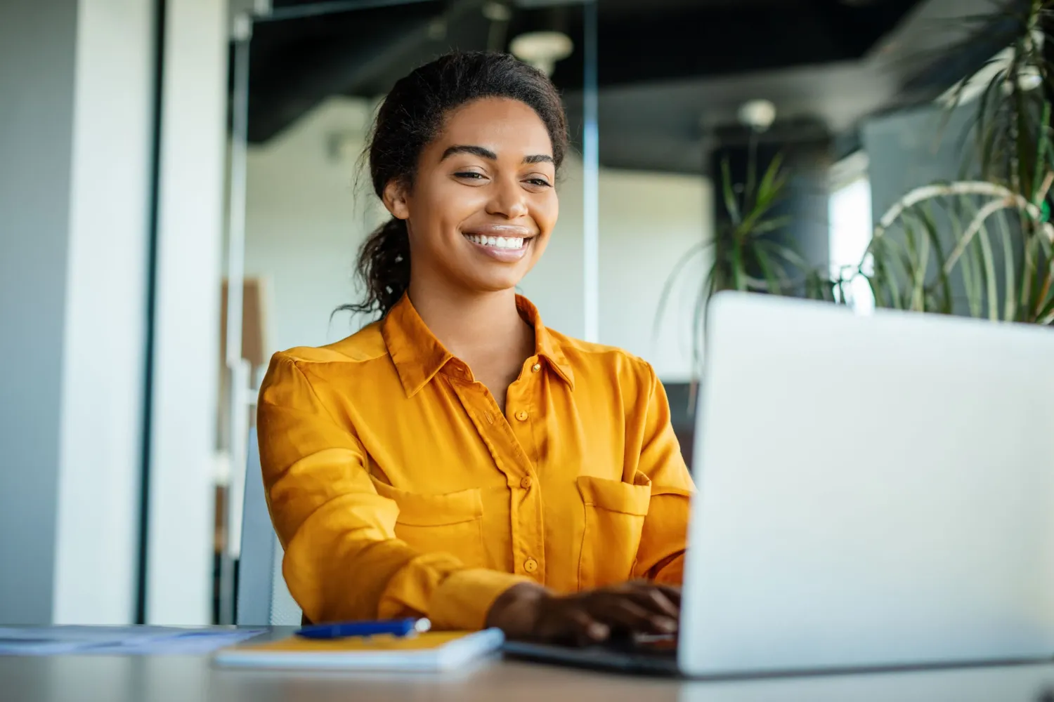 Woman smiling using a laptop